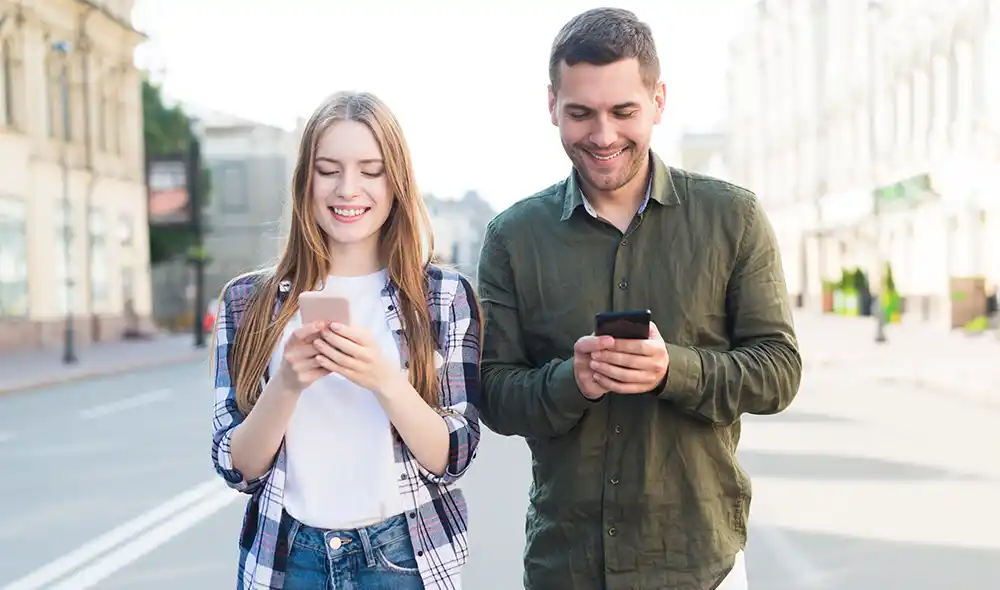 egy fiatal pár okostelefonnal Landventure szabadtéri szabadulós játékot játszik Debrecen belvárosában