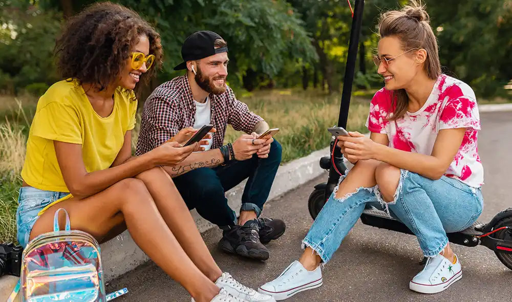 three young people take part in the Landventure scavenger hunt in Graz using their smartphone