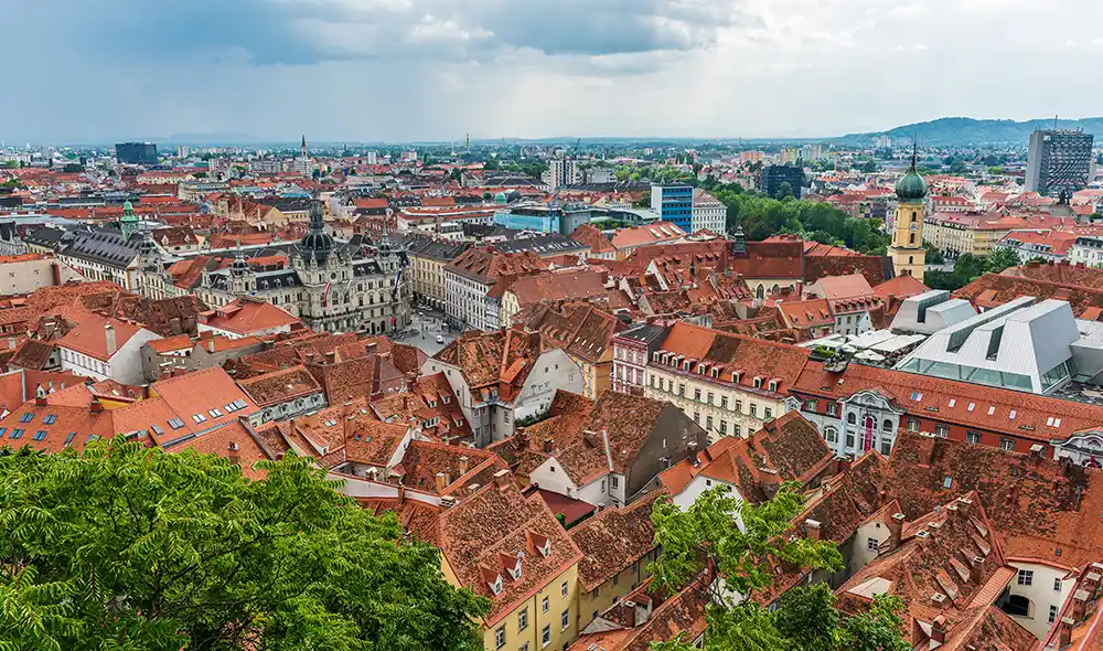 view of Graz with the clock tower and the red rooftops – exciting Landventure missions await here