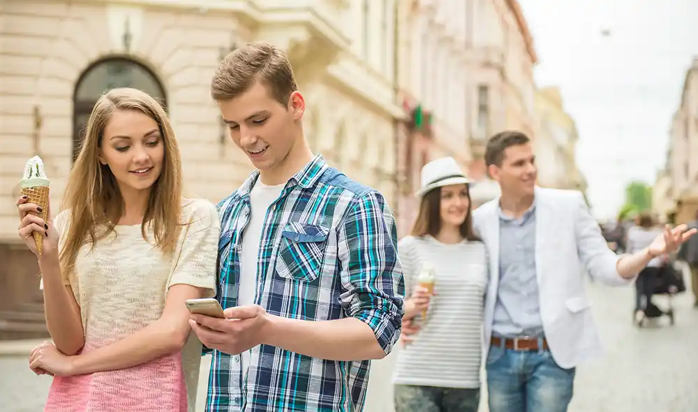 two young couples are enjoying the Landventure city adventure game in Salzburg and exploring the city center