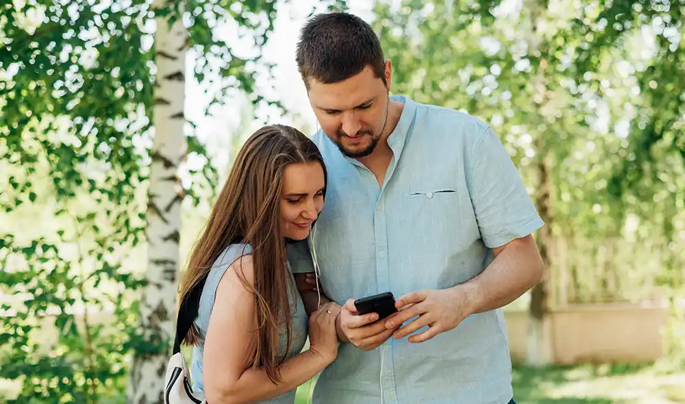 fiatal pár Landventure szabadtéri szabadulós játékot játszik Siófokon egy okostelefonnal