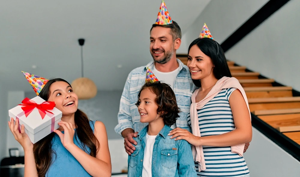 family experience gift: a cheerful family exchanging presents, including a box with a Landventure voucher